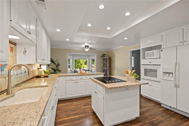 25 Misty Way, Chico, CA 95926 - kitchen featuring white appliances, a peninsula, dark wood finished floors, a tray ceiling, and recessed lighting