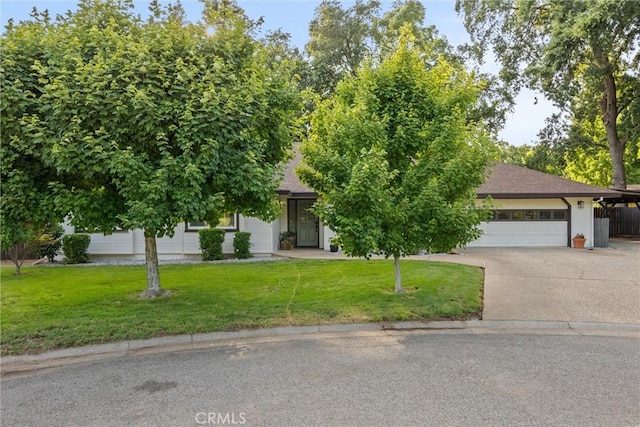 25 Misty Way, Chico, CA 95926 - obstructed view of property featuring an attached garage, concrete driveway, a front lawn, and roof with shingles