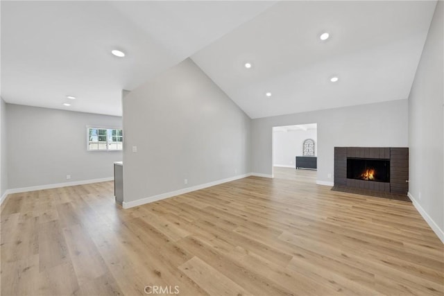 1106 W Bellbrook St, Covina, CA 91722 - unfurnished living room with a brick fireplace, light wood finished floors, vaulted ceiling, and recessed lighting