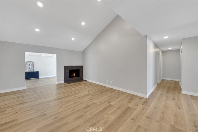 1106 W Bellbrook St, Covina, CA 91722 - unfurnished living room with light wood-style floors, a brick fireplace, lofted ceiling, and recessed lighting