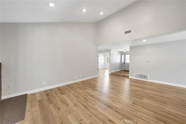 1106 W Bellbrook St, Covina, CA 91722 - unfurnished living room with light wood-type flooring, recessed lighting, and high vaulted ceiling