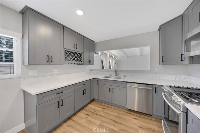 1106 W Bellbrook St, Covina, CA 91722 - kitchen with appliances with stainless steel finishes, gray cabinetry, light stone countertops, and recessed lighting