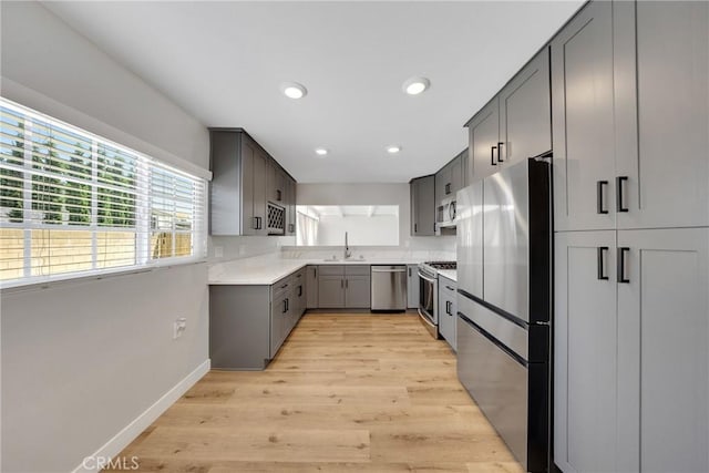 1106 W Bellbrook St, Covina, CA 91722 - kitchen featuring appliances with stainless steel finishes, light wood-type flooring, light countertops, recessed lighting, and gray cabinets