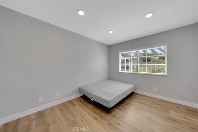 1106 W Bellbrook St, Covina, CA 91722 - bedroom with light wood-style flooring and recessed lighting