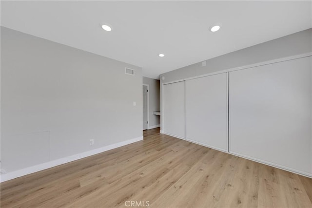 1106 W Bellbrook St, Covina, CA 91722 - unfurnished bedroom featuring light wood-style floors, a closet, and recessed lighting