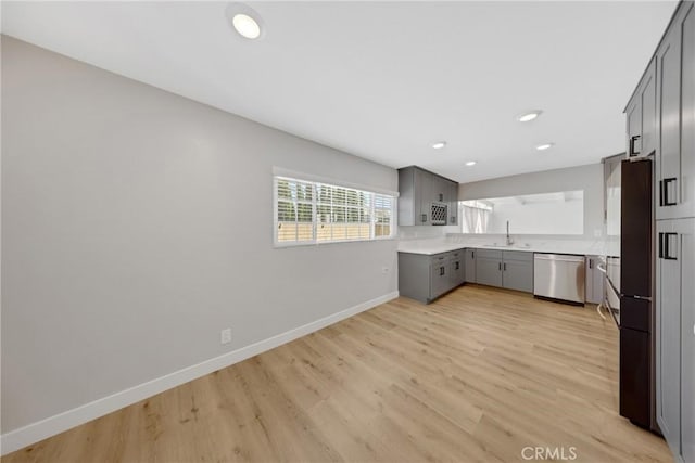 1106 W Bellbrook St, Covina, CA 91722 - kitchen featuring stainless steel dishwasher, gray cabinetry, light wood finished floors, light countertops, and freestanding refrigerator