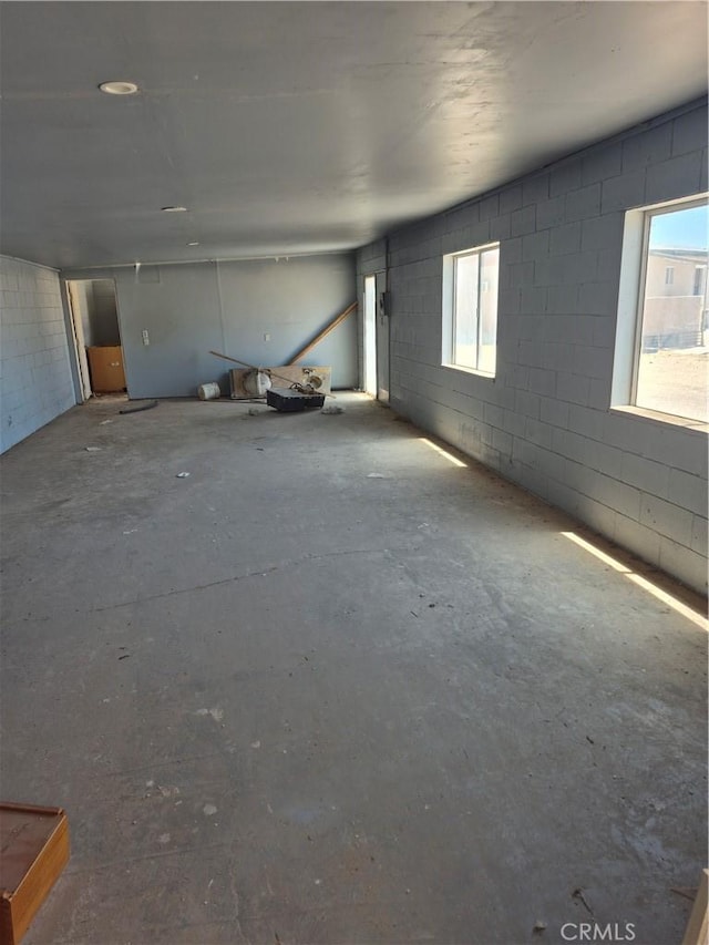 45146 Fairview Rd, Newberry Springs, CA 92365 - spare room featuring concrete block wall, concrete floors, and healthy amount of natural light