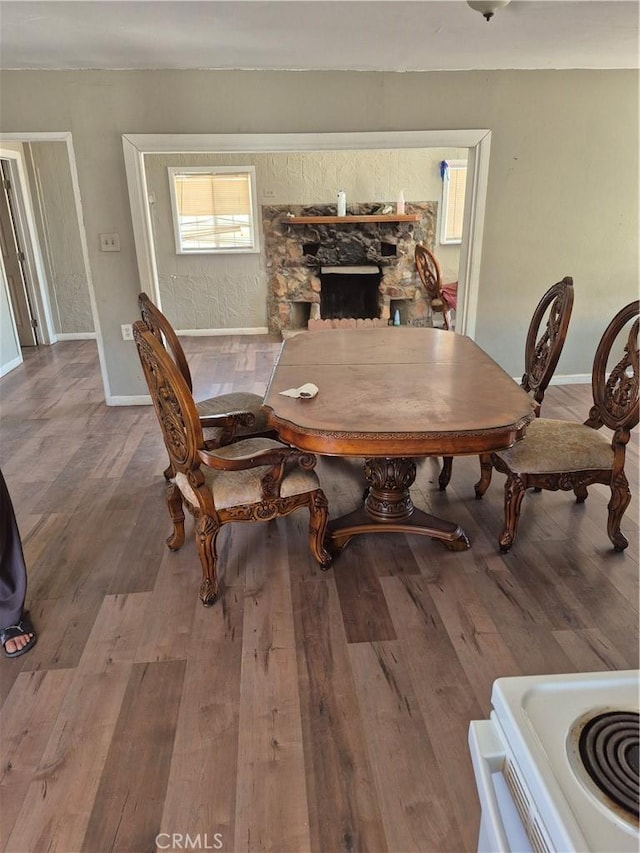 45146 Fairview Rd, Newberry Springs, CA 92365 - dining area featuring wood finished floors and a stone fireplace