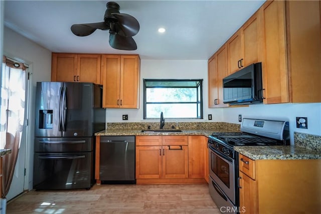 3473 Yankee Cir, Riverside, CA 92503 - kitchen with black microwave, stainless steel range with gas stovetop, dishwasher, fridge with ice dispenser, and dark stone countertops