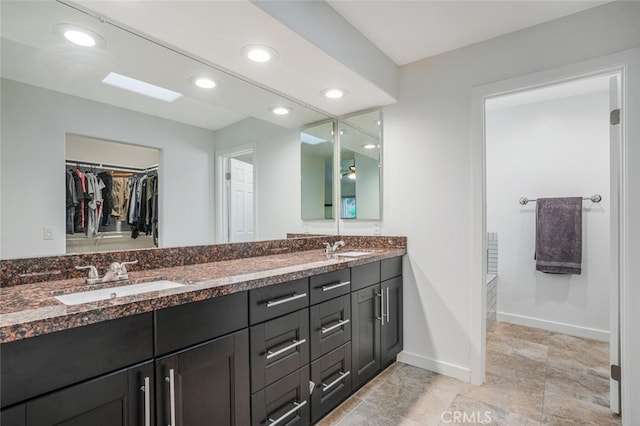 4347 Freedom Dr Unit C, Calabasas, CA 91302 - bathroom with double vanity, a walk in closet, and recessed lighting