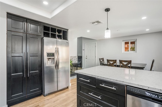 4347 Freedom Dr Unit C, Calabasas, CA 91302 - kitchen featuring stainless steel appliances, dark cabinets, light wood finished floors, pendant lighting, and light stone countertops