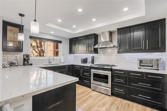 4347 Freedom Dr Unit C, Calabasas, CA 91302 - kitchen featuring gas stove, dark cabinetry, wall chimney range hood, and recessed lighting