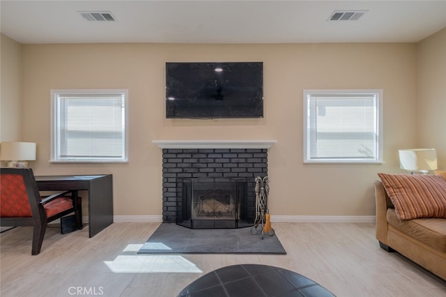 1409 4th St, San Fernando, CA 91340 - living room featuring wood finished floors and a brick fireplace