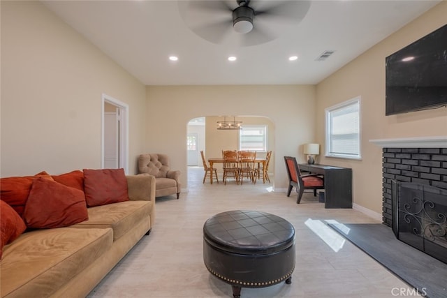 1409 4th St, San Fernando, CA 91340 - living room featuring arched walkways, recessed lighting, a ceiling fan, and a fireplace