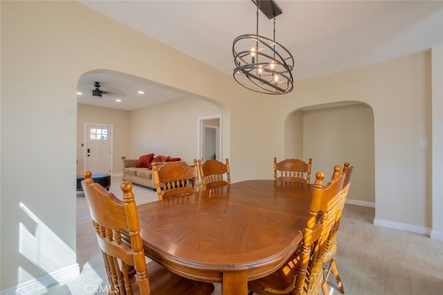 1409 4th St, San Fernando, CA 91340 - dining space with arched walkways, a chandelier, ceiling fan, light wood-style floors, and recessed lighting