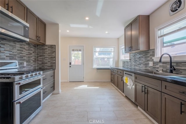 1409 4th St, San Fernando, CA 91340 - kitchen featuring appliances with stainless steel finishes, tasteful backsplash, and recessed lighting