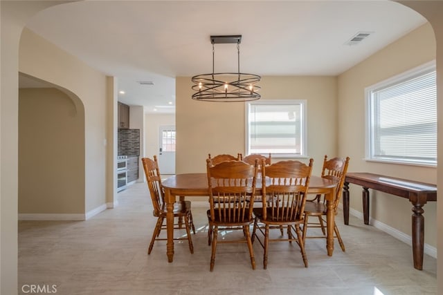 1409 4th St, San Fernando, CA 91340 - dining room featuring arched walkways, a chandelier, and recessed lighting