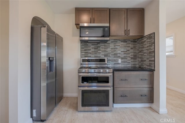 1409 4th St, San Fernando, CA 91340 - kitchen with stainless steel appliances, backsplash, and dark stone countertops