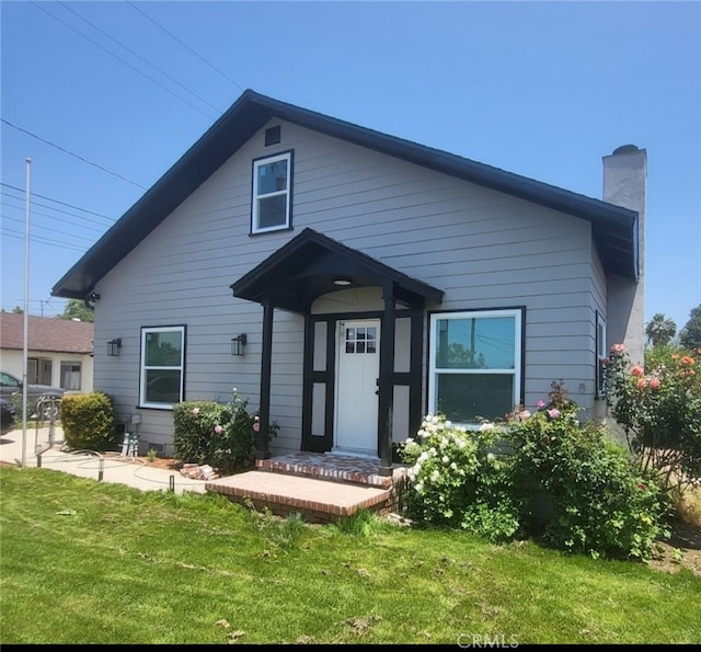 1409 4th St, San Fernando, CA 91340 - bungalow-style home featuring a front yard and a chimney