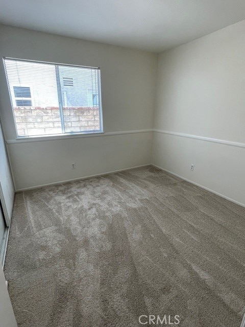 27896 Beacon St, Castaic, CA 91384 - empty room with healthy amount of natural light and carpet floors