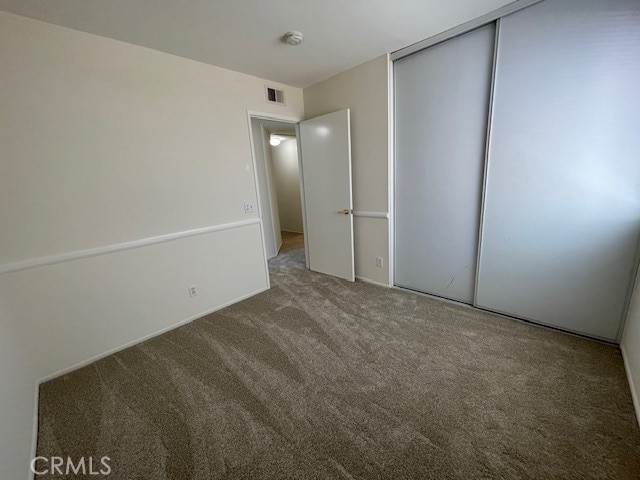 27896 Beacon St, Castaic, CA 91384 - unfurnished bedroom featuring carpet flooring and a closet