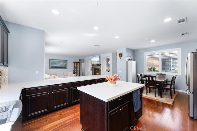 35694 Cherry Bark Way, Murrieta, CA 92562 - kitchen with freestanding refrigerator, open floor plan, light countertops, wood finished floors, and recessed lighting