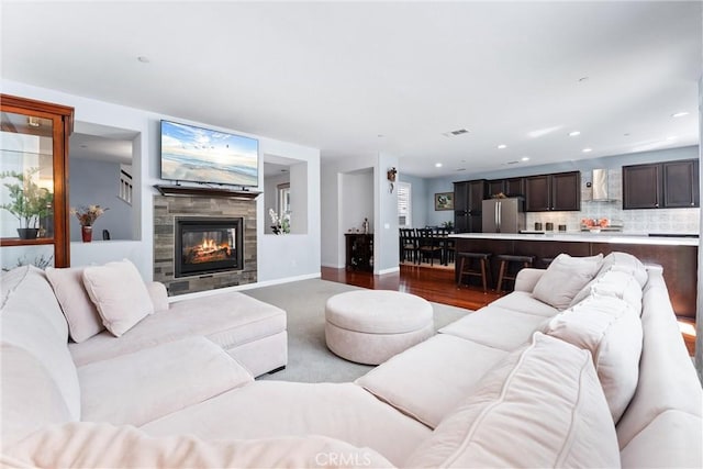 35694 Cherry Bark Way, Murrieta, CA 92562 - living room with a tile fireplace, recessed lighting, dark wood-style flooring, and dark carpet