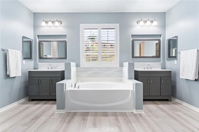 35694 Cherry Bark Way, Murrieta, CA 92562 - bathroom featuring wood finished floors, a garden tub, and two vanities