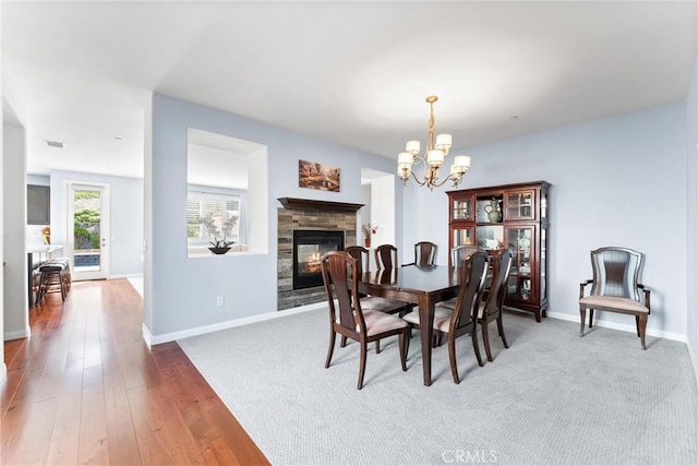 35694 Cherry Bark Way, Murrieta, CA 92562 - dining space featuring a fireplace, a chandelier, and wood finished floors