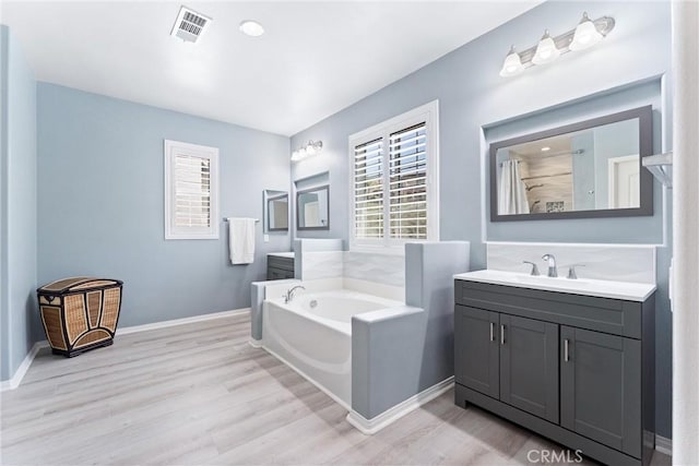 35694 Cherry Bark Way, Murrieta, CA 92562 - bathroom with healthy amount of natural light, wood finished floors, a garden tub, and vanity