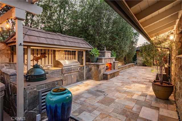 1251 Bryant Rd, Long Beach, CA 90815 - view of patio with exterior kitchen and an outdoor stone fireplace
