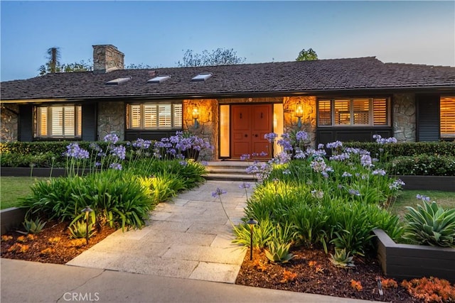 1251 Bryant Rd, Long Beach, CA 90815 - view of front facade with stone siding and a chimney