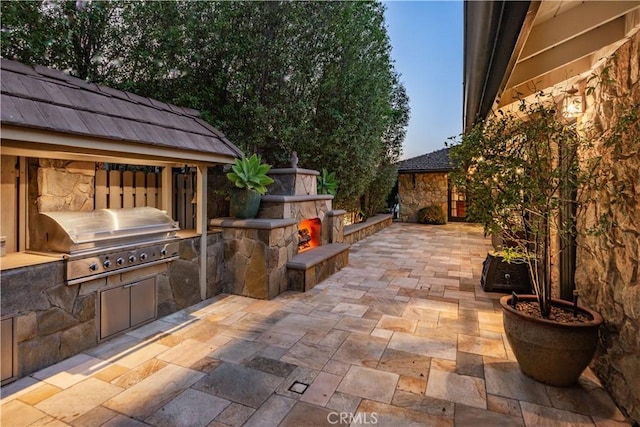 1251 Bryant Rd, Long Beach, CA 90815 - view of patio / terrace with an outdoor stone fireplace and area for grilling