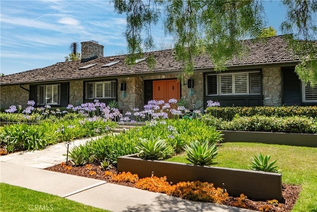 1251 Bryant Rd, Long Beach, CA 90815 - ranch-style home with stone siding, a chimney, and a front lawn