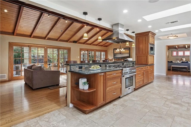 1251 Bryant Rd, Long Beach, CA 90815 - kitchen featuring island range hood, stainless steel appliances, open floor plan, a skylight, and brown cabinetry