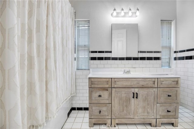 8140 Quartz Ave, Winnetka, CA 91306 - full bath with tile walls, vanity, tile patterned floors, and a shower with shower curtain