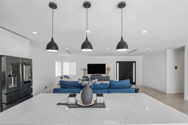 8140 Quartz Ave, Winnetka, CA 91306 - kitchen featuring refrigerator with ice dispenser, white cabinets, hanging light fixtures, recessed lighting, and light wood-style floors