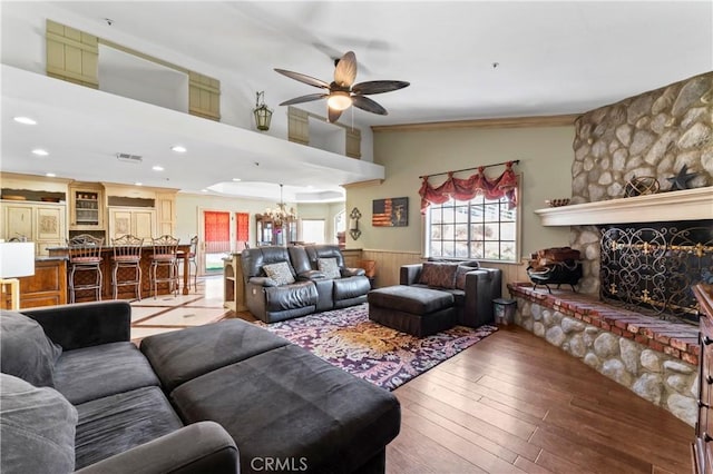 34037 Agua Dulce Canyon Rd, Agua Dulce, CA 91390 - living room featuring a ceiling fan, a wainscoted wall, a stone fireplace, plenty of natural light, and a chandelier
