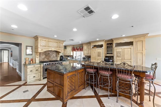 34037 Agua Dulce Canyon Rd, Agua Dulce, CA 91390 - kitchen featuring cream cabinetry, high end appliances, recessed lighting, ornamental molding, and inlaid floor details