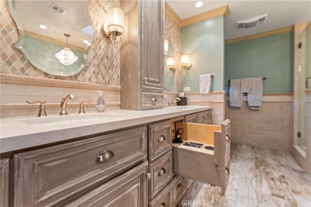 34037 Agua Dulce Canyon Rd, Agua Dulce, CA 91390 - bathroom with tile walls, double vanity, crown molding, a chandelier, and wainscoting