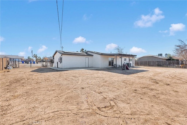 12684 Snapping Turtle Rd, Apple Valley, CA 92308 - rear view of house featuring roof mounted solar panels, a patio area, and a fenced backyard