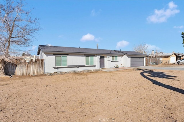 12684 Snapping Turtle Rd, Apple Valley, CA 92308 - view of front facade featuring stucco siding, an attached garage, and driveway