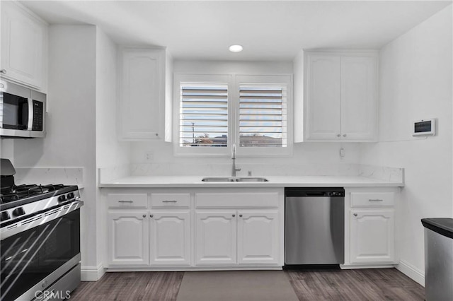 12684 Snapping Turtle Rd, Apple Valley, CA 92308 - kitchen with stainless steel appliances, dark wood-style flooring, and white cabinets