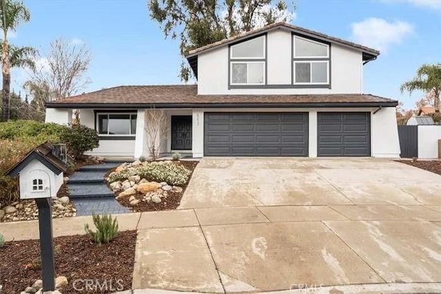 6212 Sacramento Ave, Rancho Cucamonga, CA 91701 - view of front of house with an attached garage, stucco siding, and concrete driveway