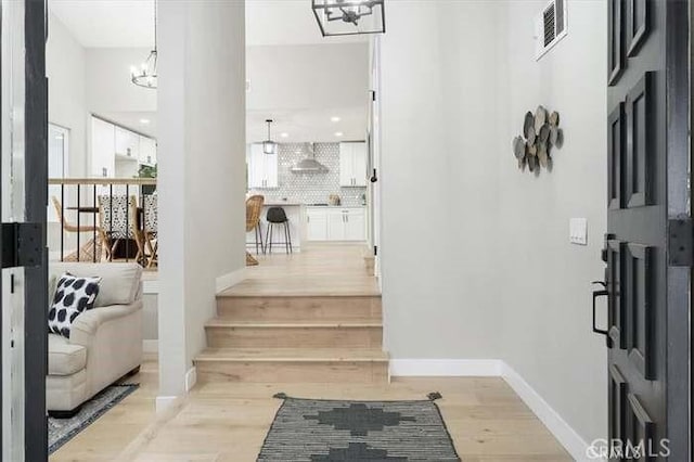6212 Sacramento Ave, Rancho Cucamonga, CA 91701 - foyer entrance with light wood-type flooring and a chandelier