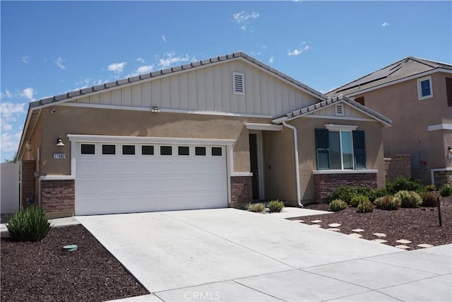 27082 Nolana Way, Menifee, CA 92584 - craftsman house featuring driveway, stone siding, an attached garage, and stucco siding