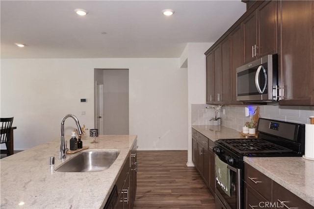 27082 Nolana Way, Menifee, CA 92584 - kitchen with stainless steel appliances, decorative backsplash, dark brown cabinetry, dark wood-style flooring, and recessed lighting