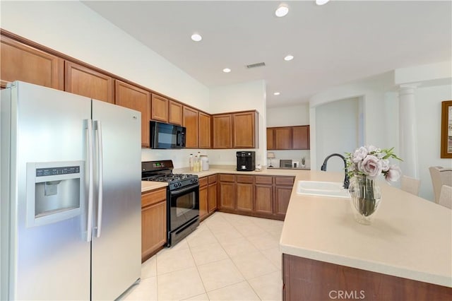 24038 Watercress Dr, Corona, CA 92883 - kitchen featuring black appliances, brown cabinetry, light countertops, light tile patterned floors, and recessed lighting