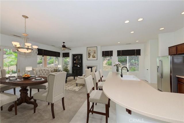 24038 Watercress Dr, Corona, CA 92883 - dining room with recessed lighting, light carpet, a chandelier, and ceiling fan