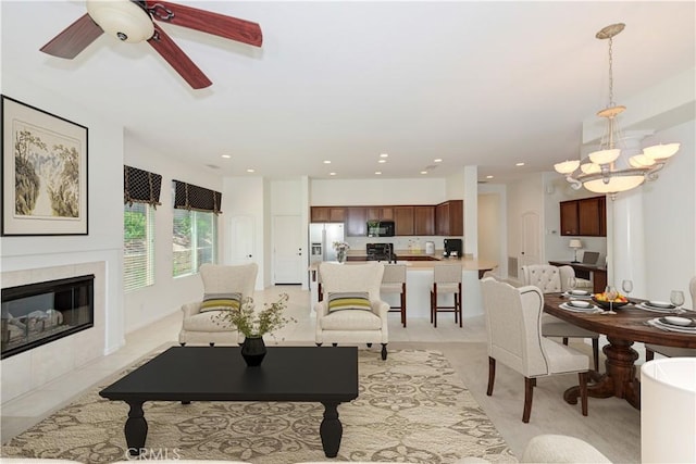 24038 Watercress Dr, Corona, CA 92883 - living area with a chandelier, a tiled fireplace, a ceiling fan, and recessed lighting